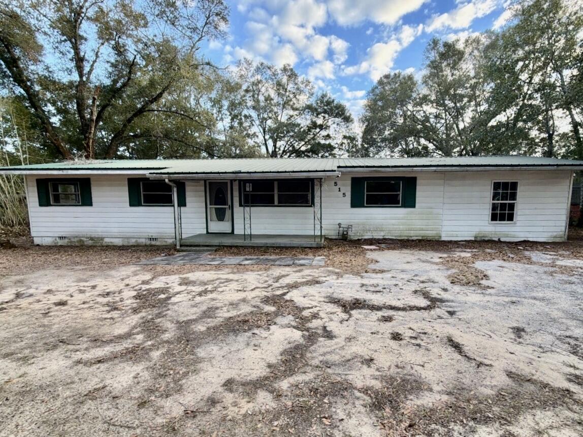 515 Robinson Avenue East Crestview, FL 32539 - Photo 1 of 22 a front view of a house with garden