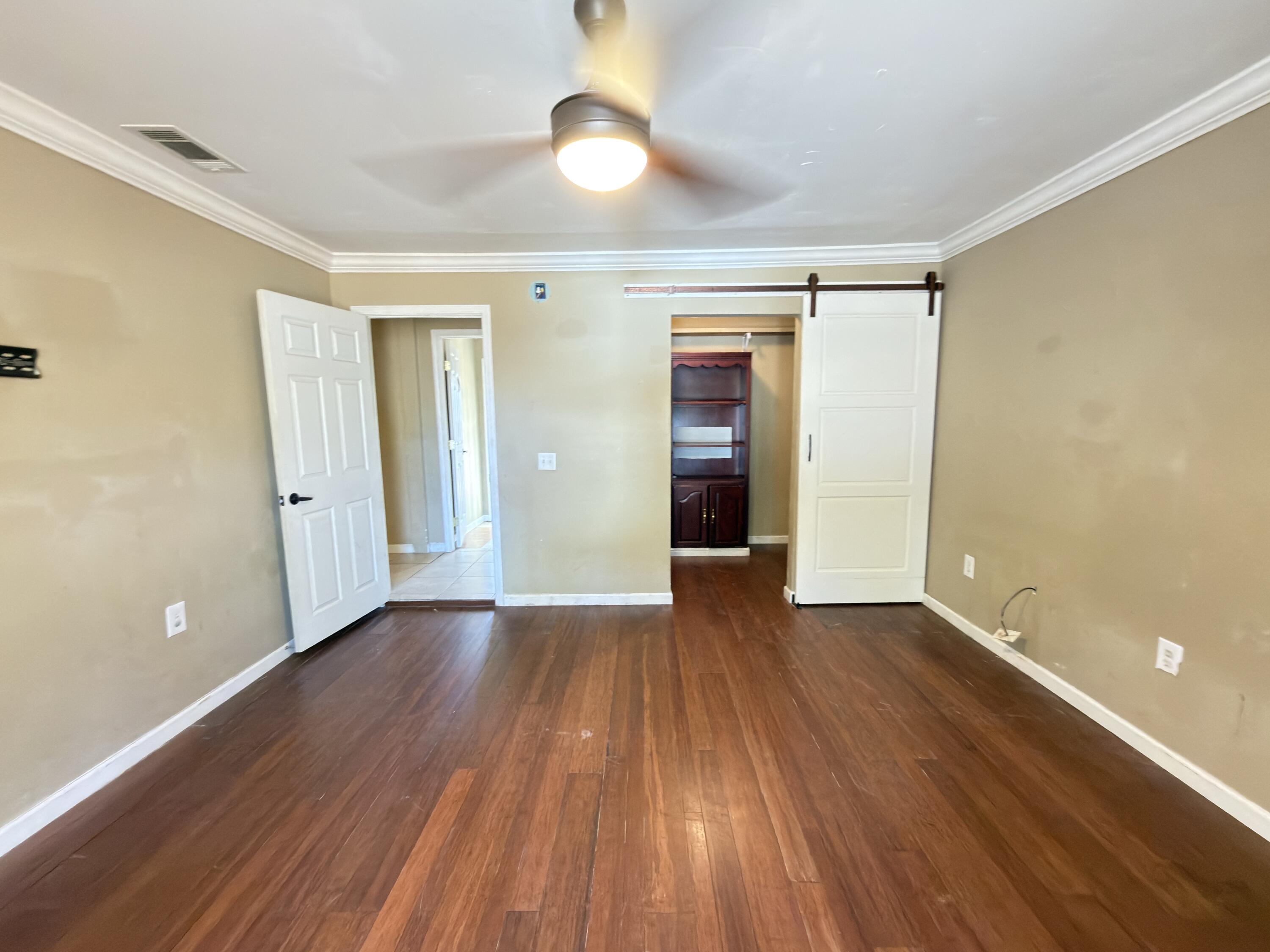 515 Robinson Avenue East Crestview, FL 32539 - Photo 11 of 22 wooden floor in an empty room with a window