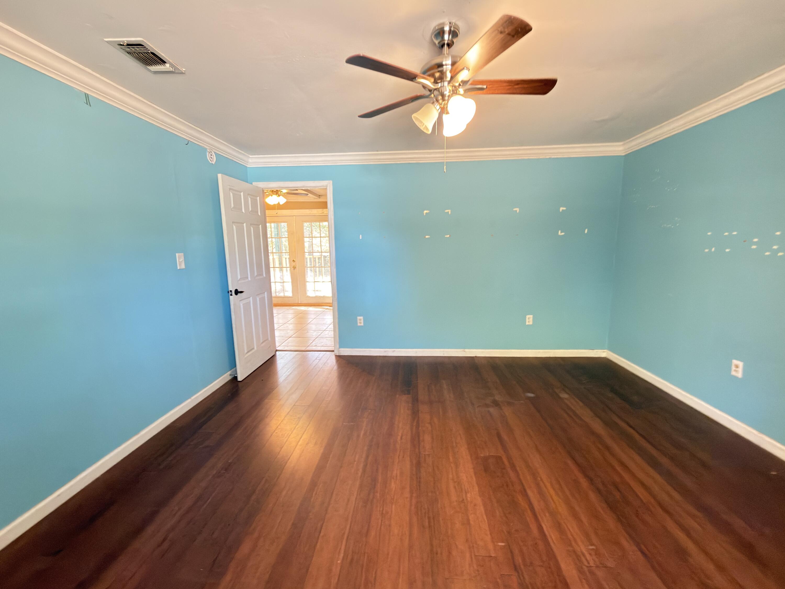515 Robinson Avenue East Crestview, FL 32539 - Photo 14 of 22 wooden floor in an empty room with a window