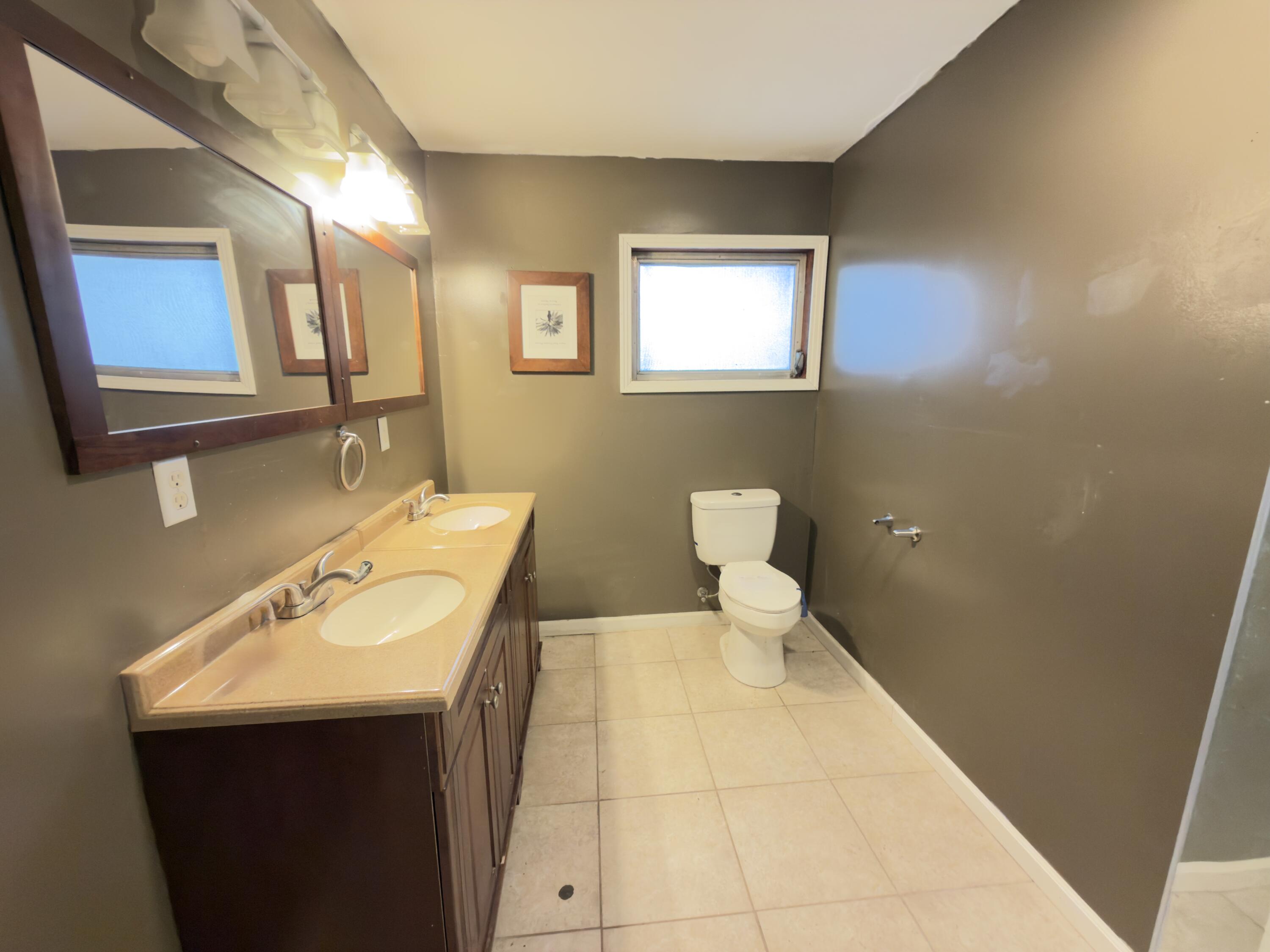 515 Robinson Avenue East Crestview, FL 32539 - Photo 16 of 22 a bathroom with a sink a toilet and mirror