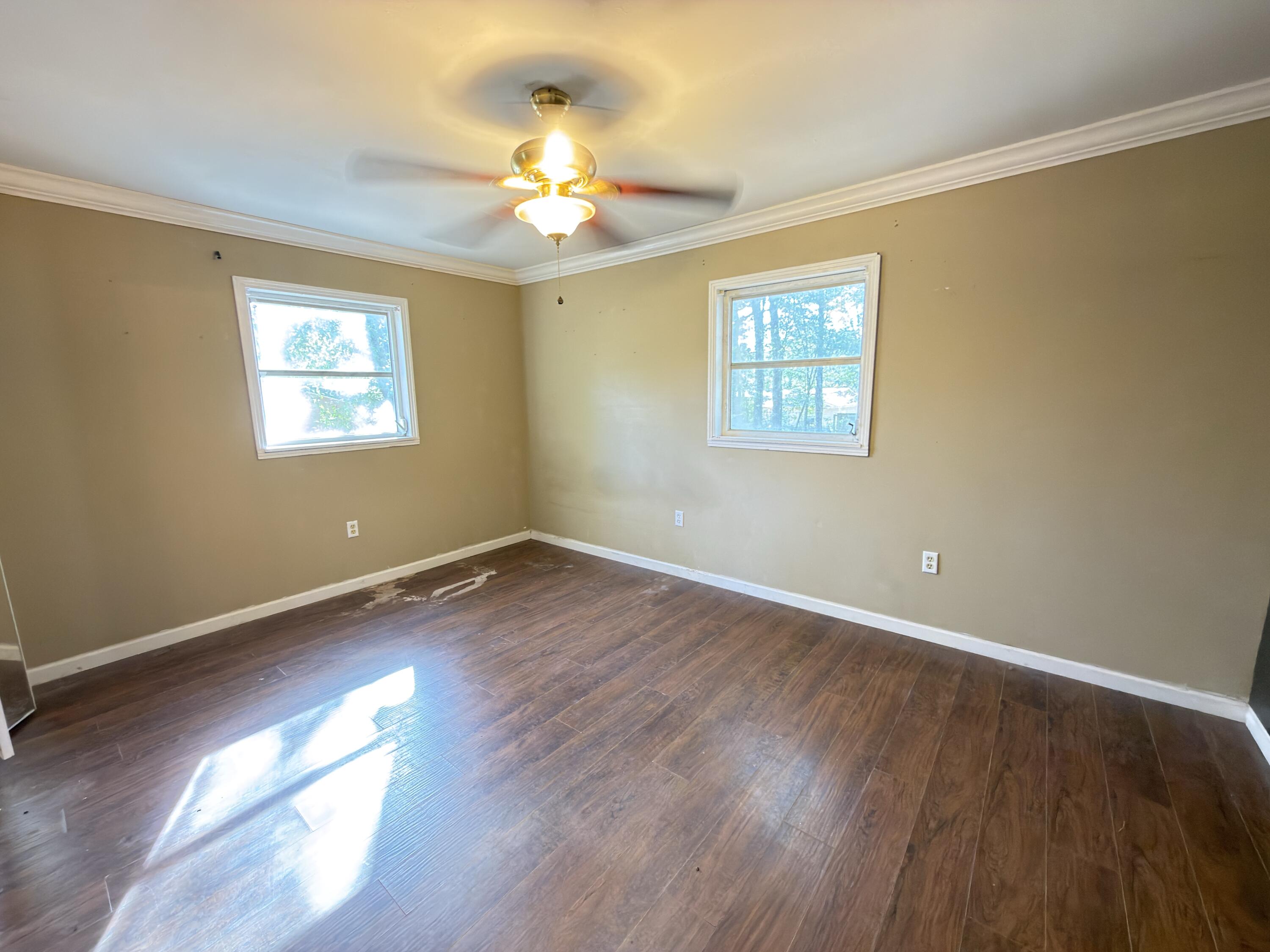 515 Robinson Avenue East Crestview, FL 32539 - Photo 19 of 22 a view of an empty room with wooden floor and a window