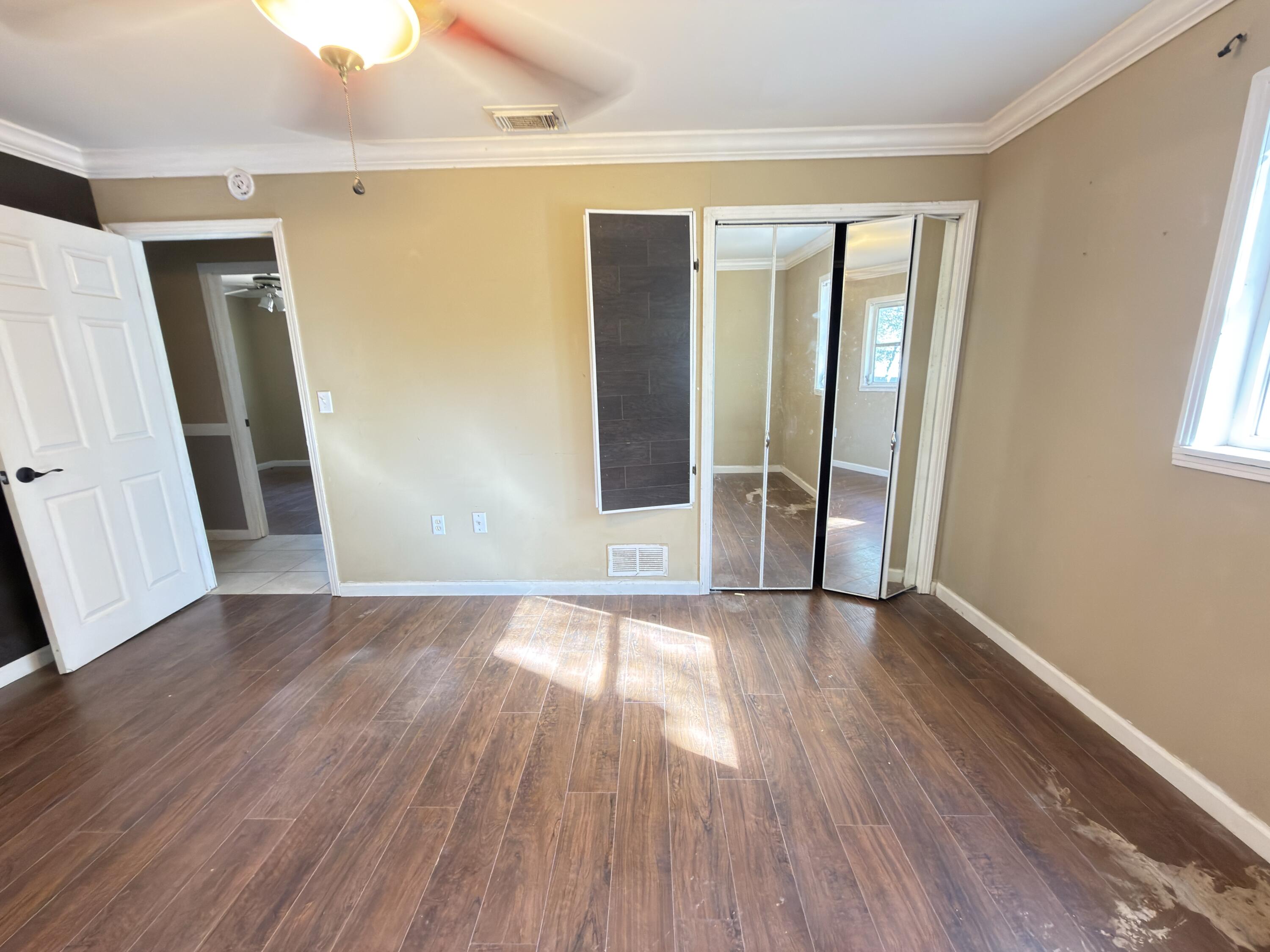 515 Robinson Avenue East Crestview, FL 32539 - Photo 20 of 22 an empty room with wooden floor and a window