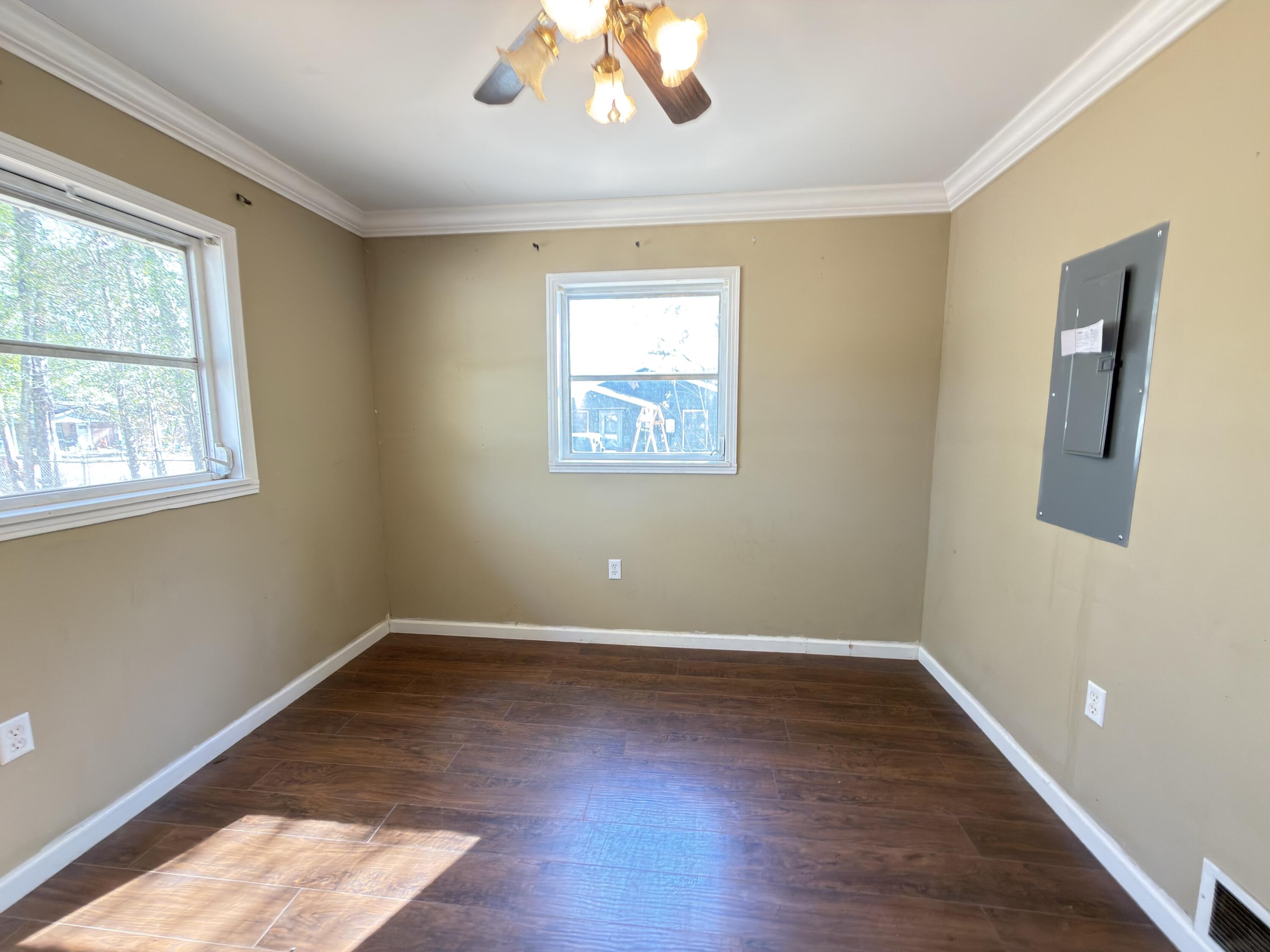 515 Robinson Avenue East Crestview, FL 32539 - Photo 22 of 22 a view of an empty room with wooden floor and a window