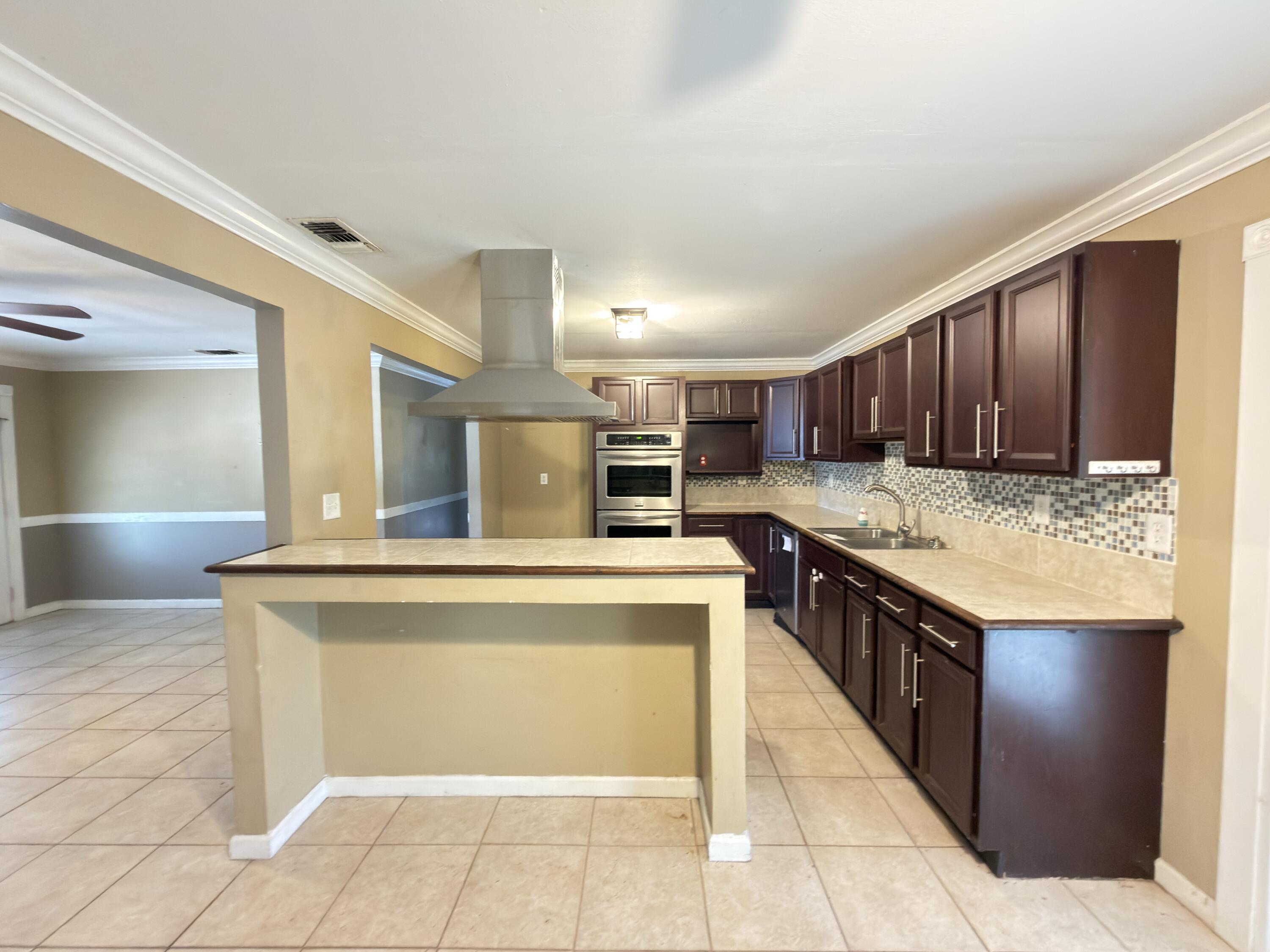 515 Robinson Avenue East Crestview, FL 32539 - Photo 4 of 22 a kitchen with stainless steel appliances granite countertop a stove and a refrigerator