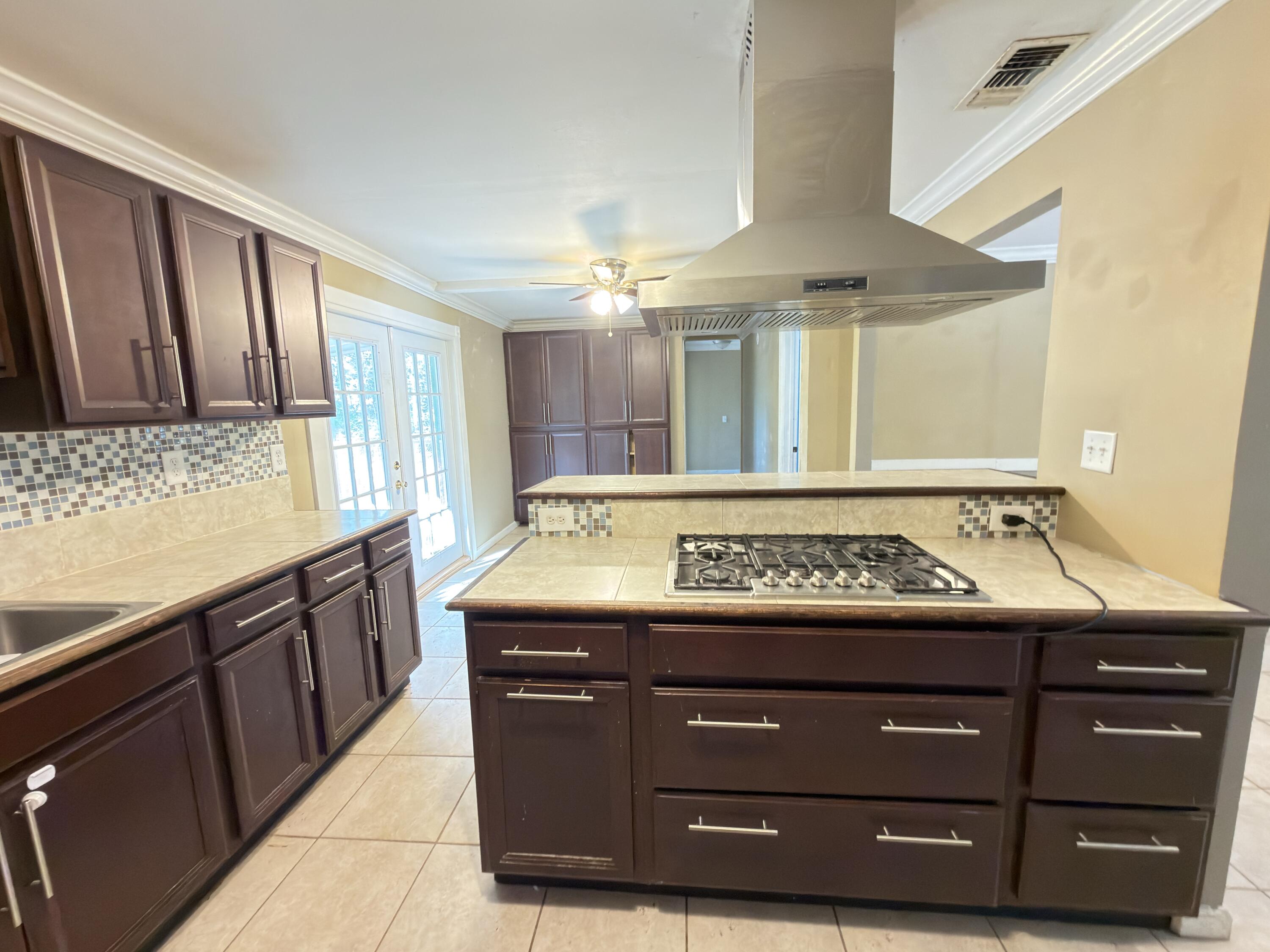 515 Robinson Avenue East Crestview, FL 32539 - Photo 6 of 22 a bathroom with a granite countertop sink and a stove