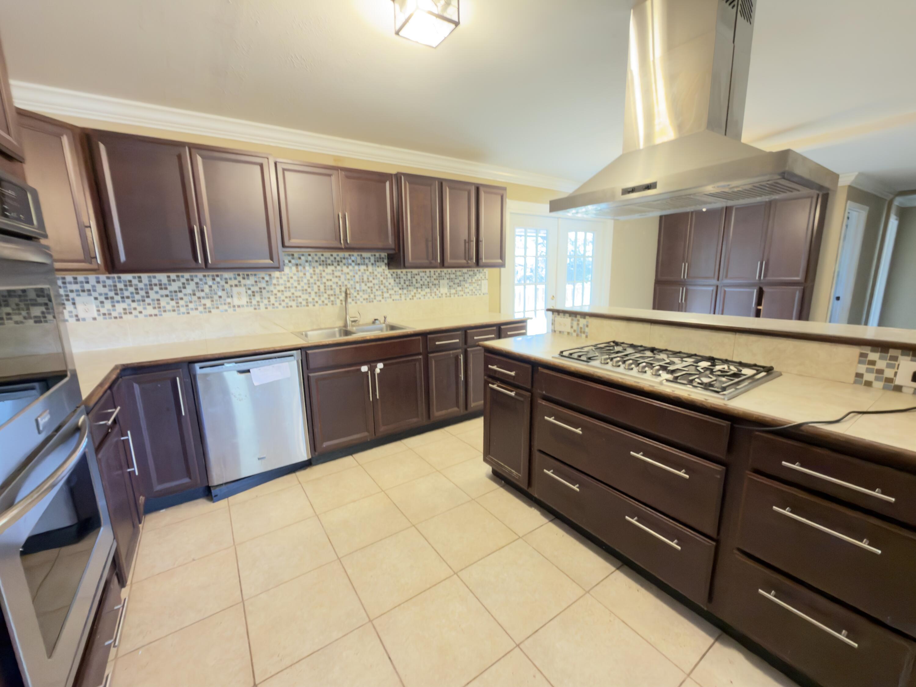 515 Robinson Avenue East Crestview, FL 32539 - Photo 8 of 22 a kitchen with stainless steel appliances granite countertop wooden cabinets a sink and dishwasher
