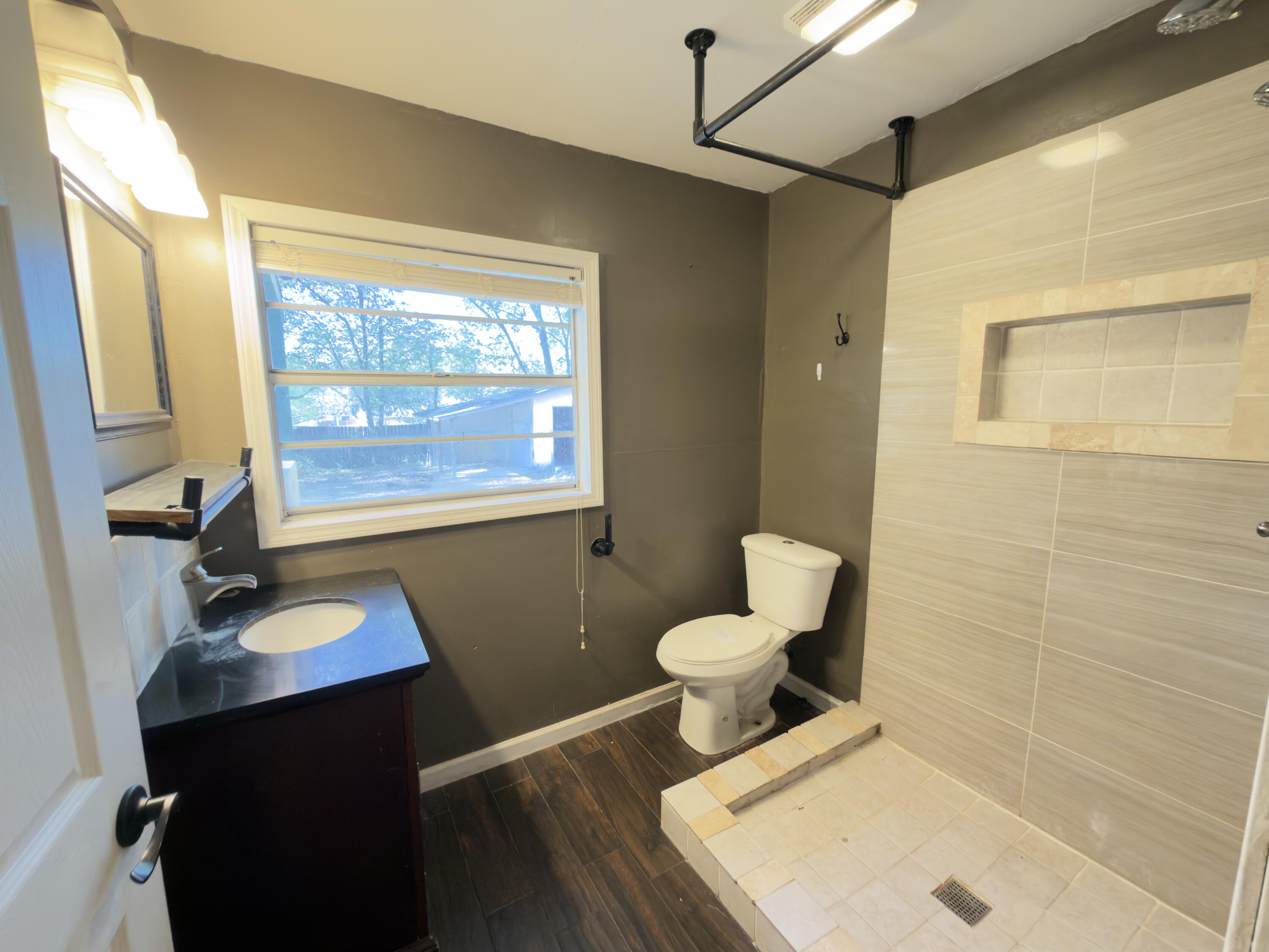 515 Robinson Avenue East Crestview, FL 32539 - Photo 9 of 22 a bathroom with a sink toilet and window