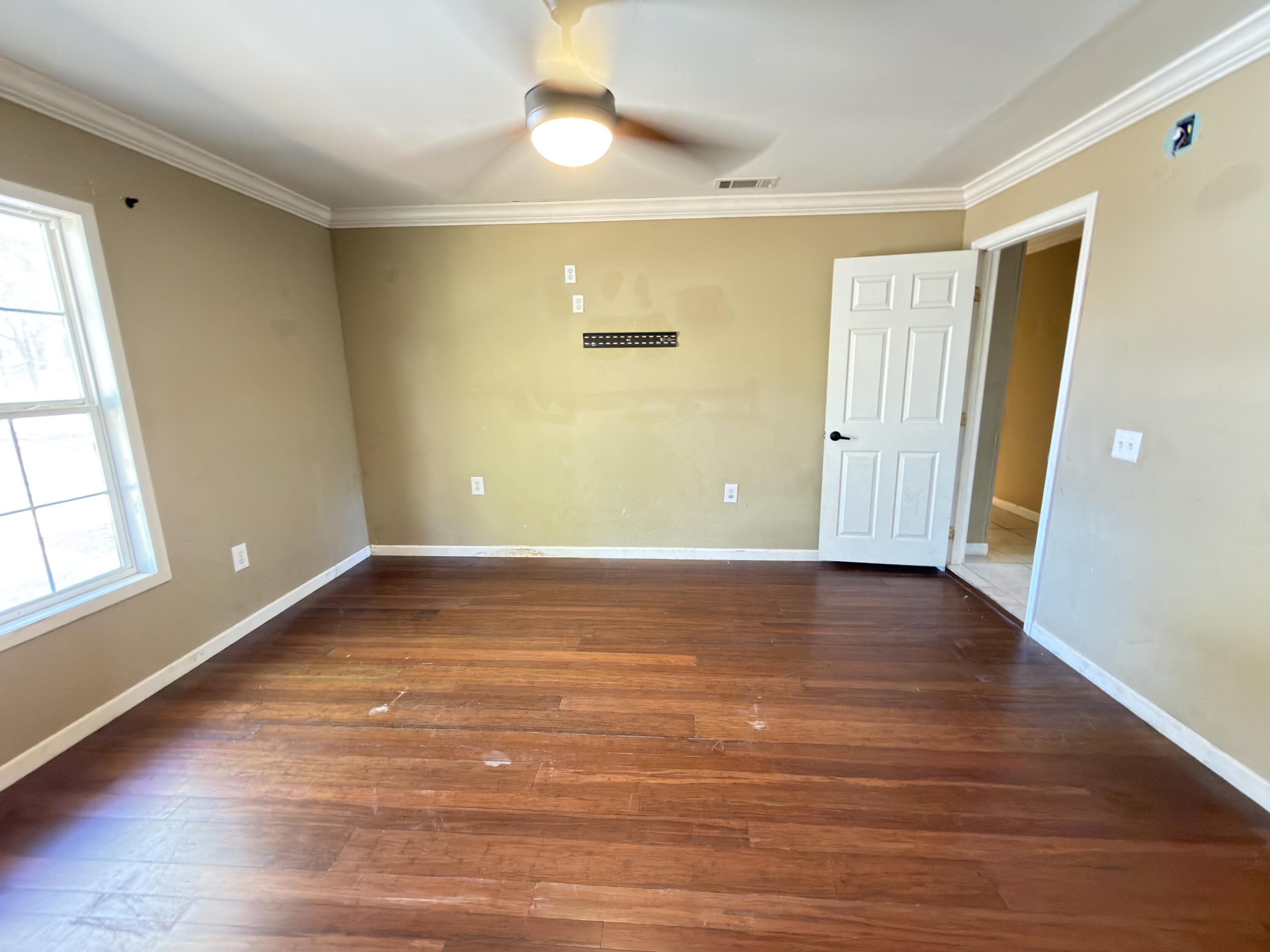 515 Robinson Avenue East Crestview, FL 32539 - Photo 10 of 22 a view of an empty room with wooden floor
