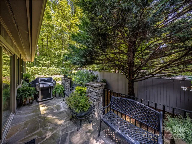 a view of house with outdoor seating and plants