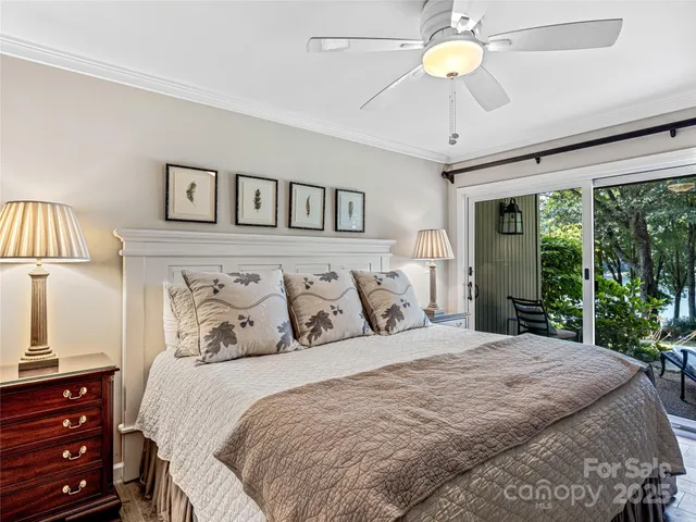 a bedroom with a large bed and a chandelier