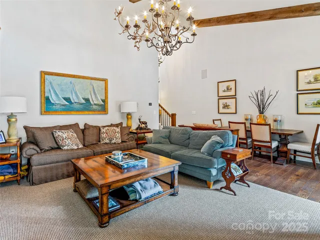 a living room with furniture and a chandelier