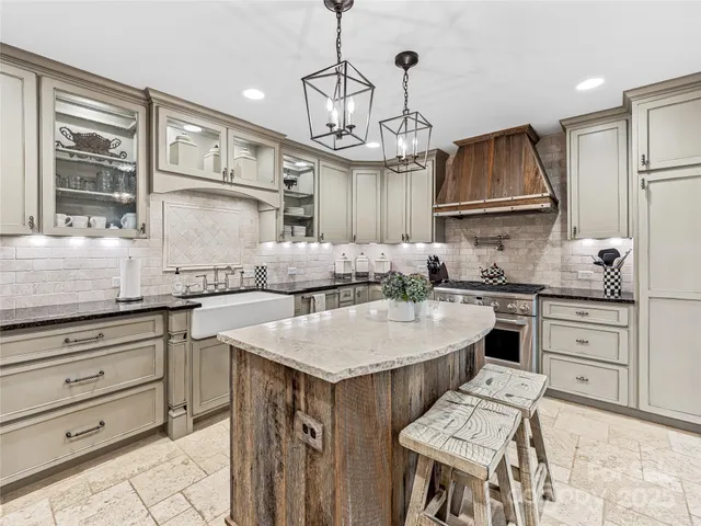 a kitchen with a sink stove and cabinets