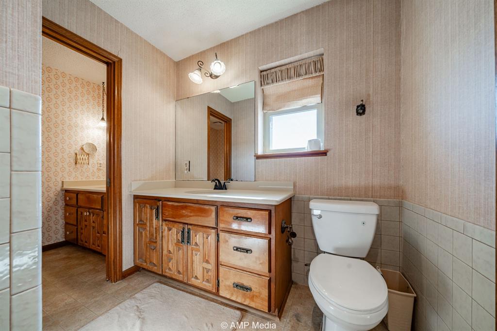 1102 Elmdale Road North Abilene, TX 79601 - Photo 13 of 28 a bathroom with a toilet sink and mirror