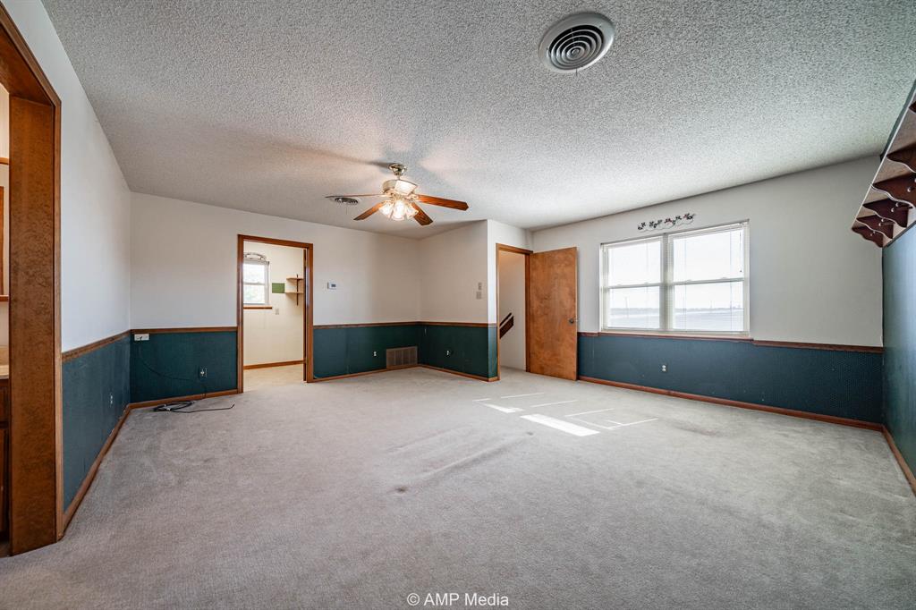 1102 Elmdale Road North Abilene, TX 79601 - Photo 14 of 28 an empty room with windows and cabinet
