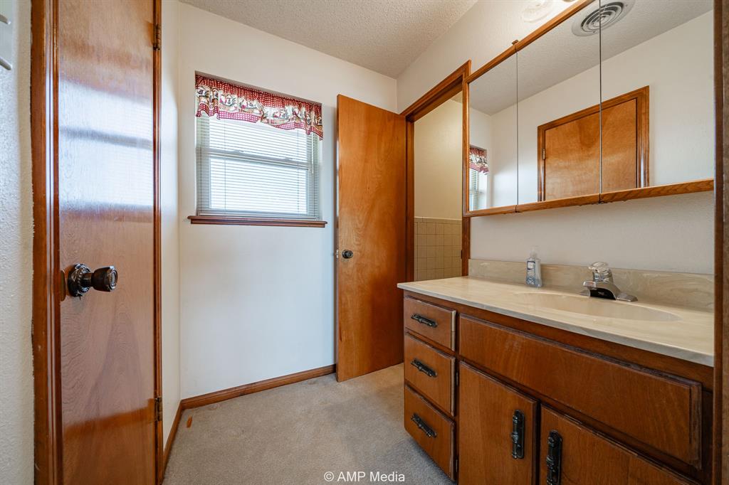 1102 Elmdale Road North Abilene, TX 79601 - Photo 15 of 28 a kitchen with a sink and a refrigerator