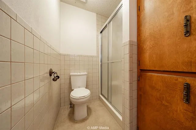 a view of a kitchen with stainless steel appliances granite countertop wooden cabinets and a sink