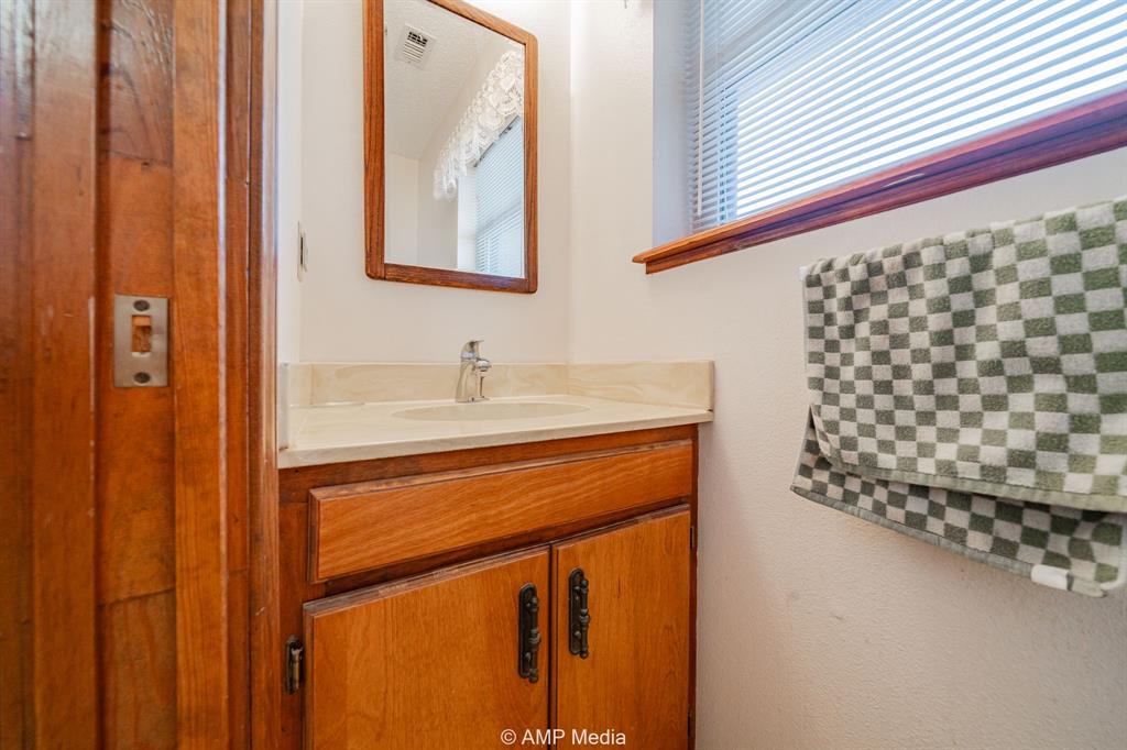 1102 Elmdale Road North Abilene, TX 79601 - Photo 18 of 28 a bathroom with a sink and a mirror