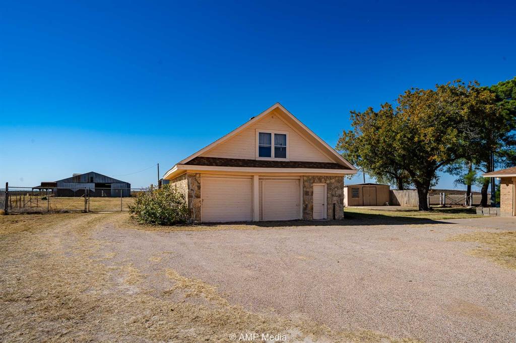 1102 Elmdale Road North Abilene, TX 79601 - Photo 20 of 28 a front view of a house with a yard and garage