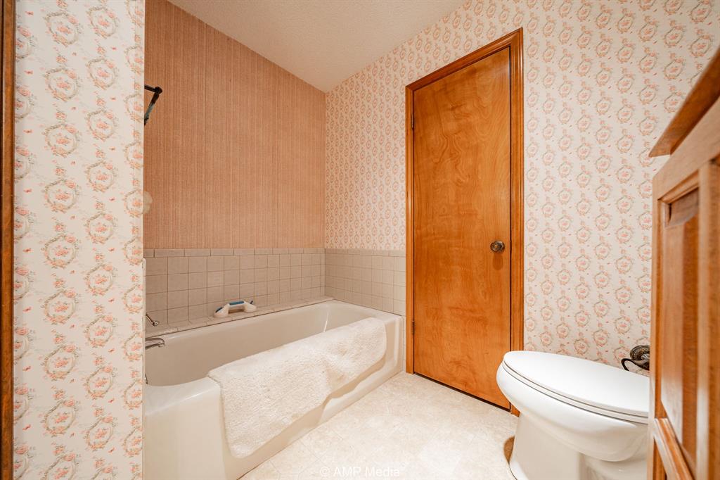 1102 Elmdale Road North Abilene, TX 79601 - Photo 10 of 28 a bathroom with a toilet and shower