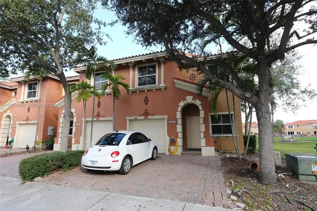 a car parked in front of white house