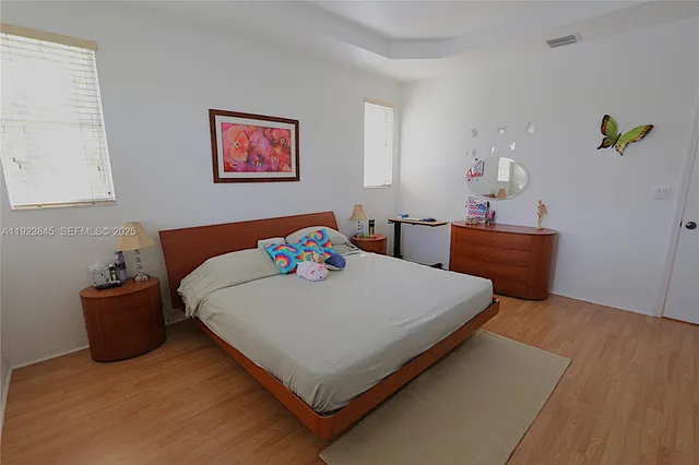 a bed sitting in a bedroom next to a window