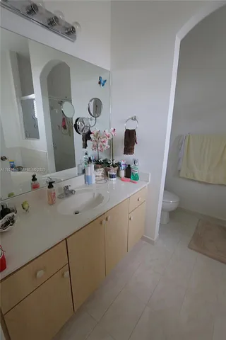 a bathroom with a double vanity sink and mirror