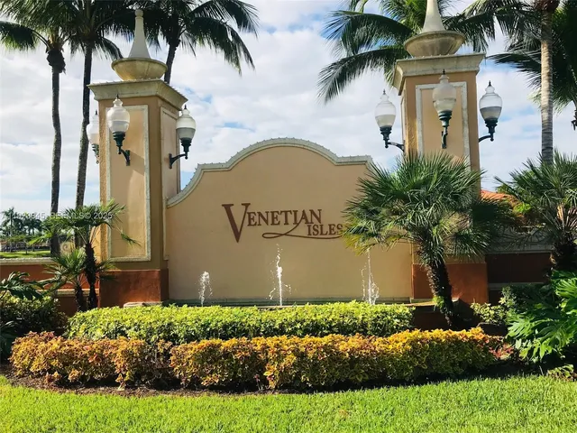 a front view of a house with garden and plants
