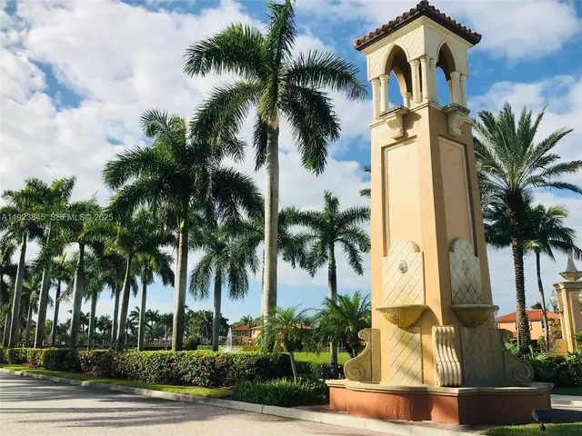 a front view of house with palm trees