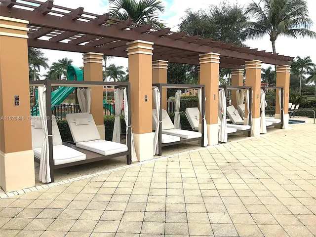 a view of a patio with a table and chairs next to a yard