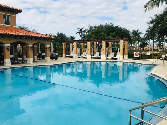 an outdoor view of swimming pool with outdoor seating