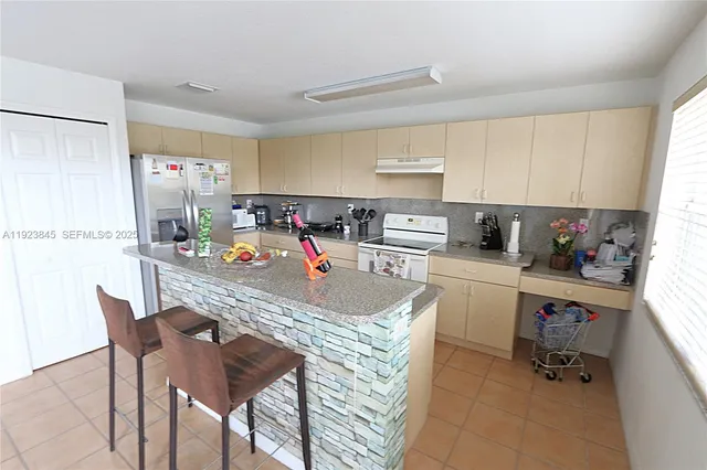 a kitchen with stainless steel appliances granite countertop a sink and cabinets