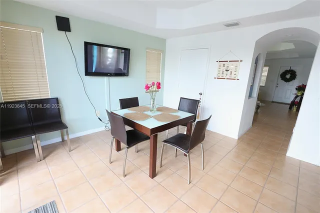 a view of a livingroom with furniture and a flat screen tv
