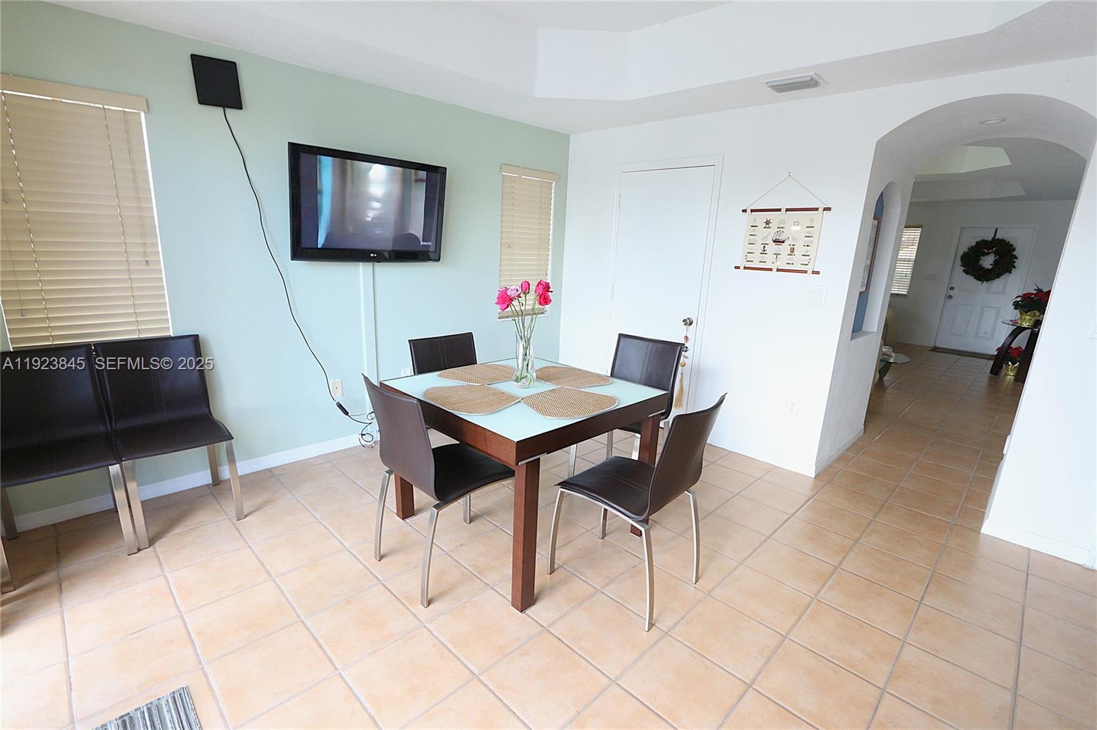 15315 Southwest 31st Terrace, Unit 15315 Miami, FL 33185 - Photo 8 of 35 a view of a livingroom with furniture and a flat screen tv