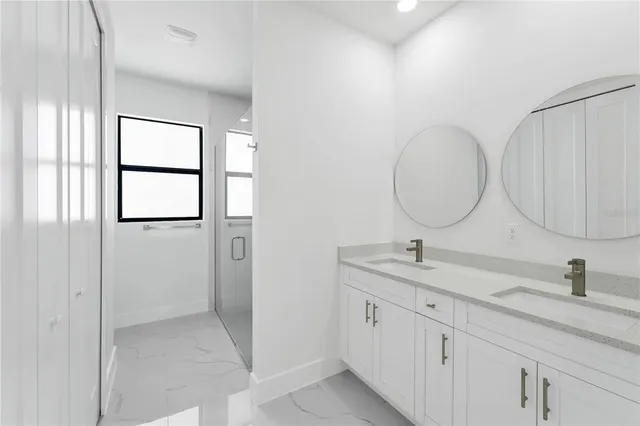 a bathroom with a double vanity sink and a mirror