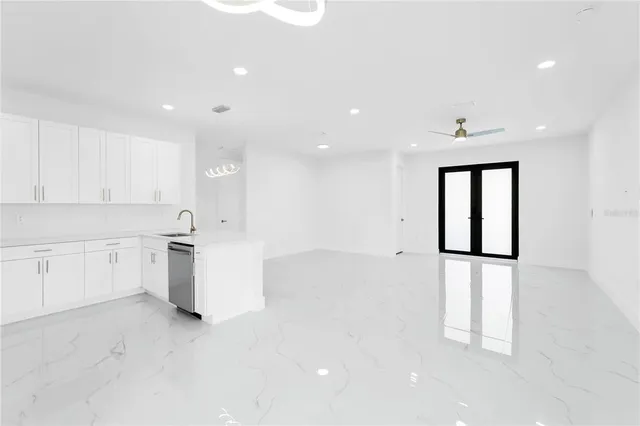 a kitchen with white cabinets and white appliances