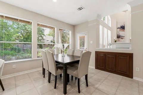 a dining room with furniture and window