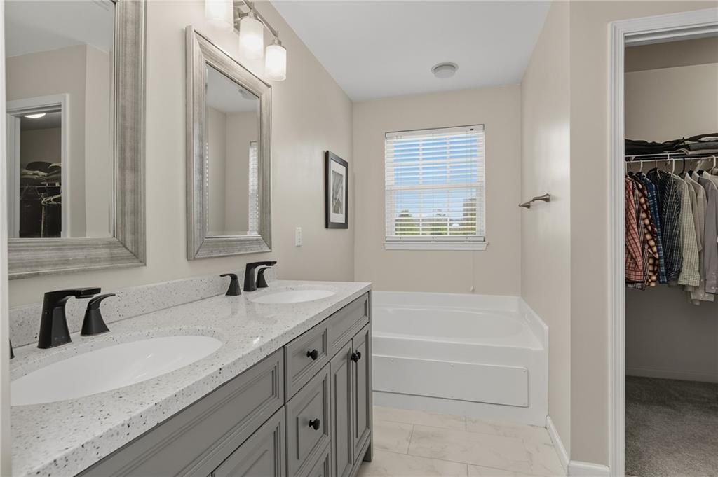 207 Windham Lane Mars, PA 16046 - Photo 22 of 43 a bathroom with a granite countertop tub sink and mirror