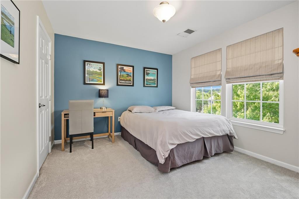 207 Windham Lane Mars, PA 16046 - Photo 25 of 43 a spacious bedroom with a bed table and a window