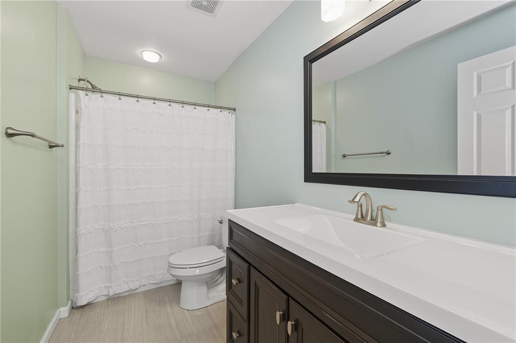 207 Windham Lane Mars, PA 16046 - Photo 28 of 43 a bathroom with a sink a toilet a mirror and shower