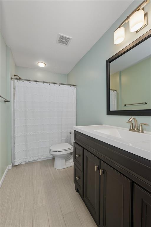 207 Windham Lane Mars, PA 16046 - Photo 29 of 43 a bathroom with a granite countertop sink a toilet and a mirror