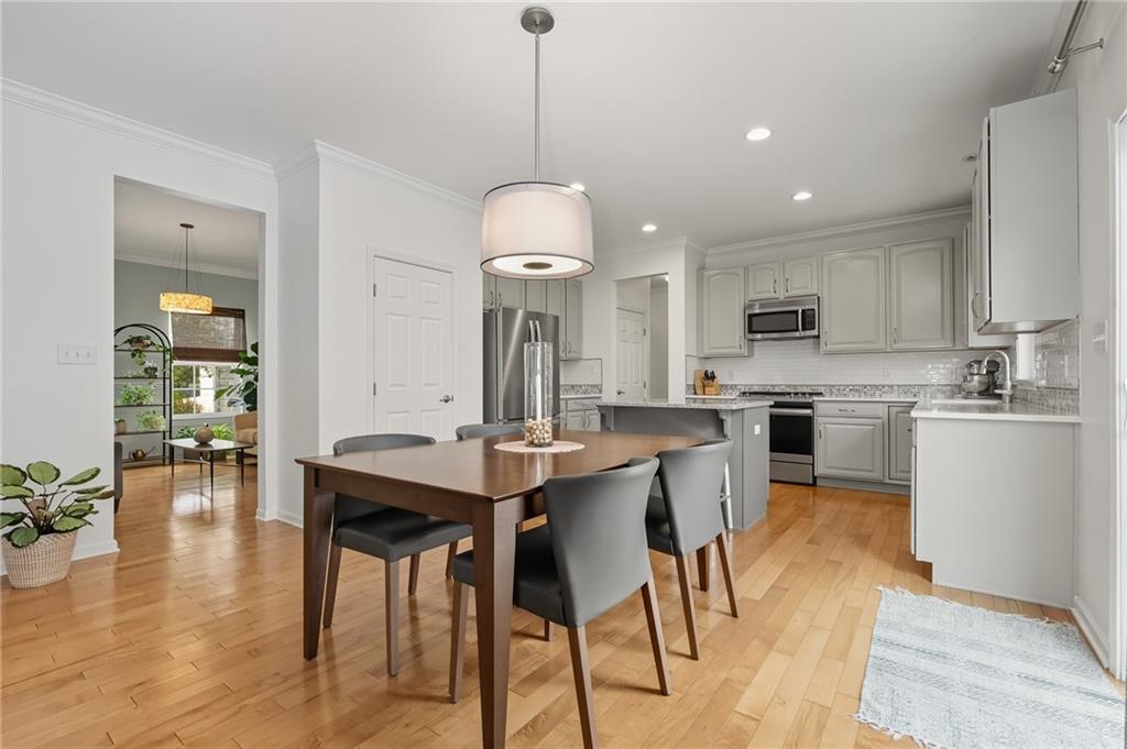 207 Windham Lane Mars, PA 16046 - Photo 10 of 43 a kitchen with stainless steel appliances kitchen island granite countertop a table chairs and a refrigerator
