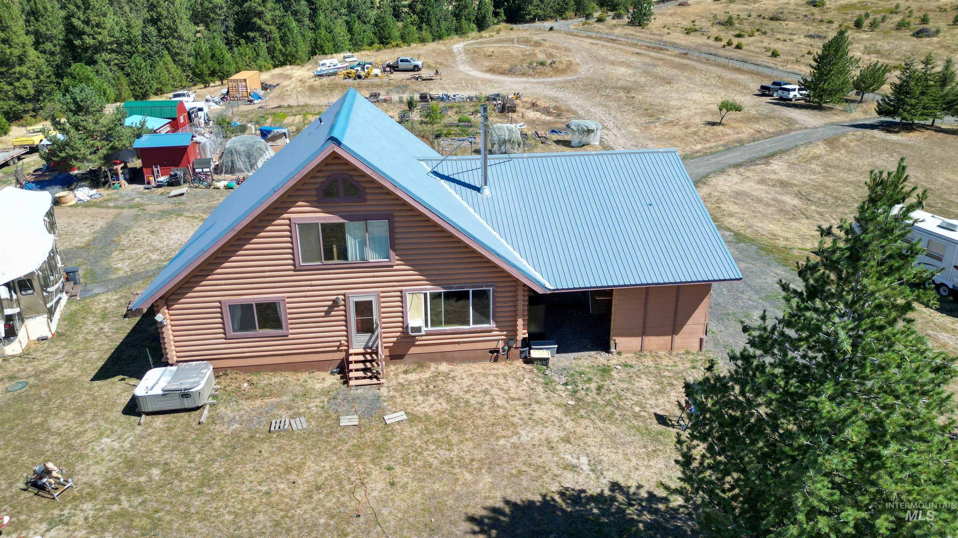 1321 Gold Hill Road Princeton, ID 83857 - Photo 26 of 29 Extensive property featuring multiple outbuildings, mature evergreen trees, open land, and a winding driveway