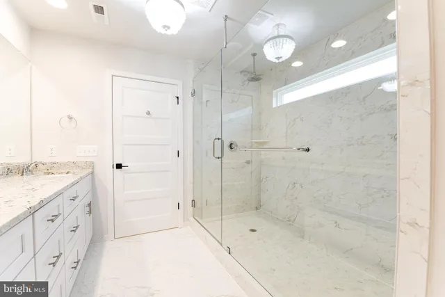 a bathroom with a shower sink and mirror