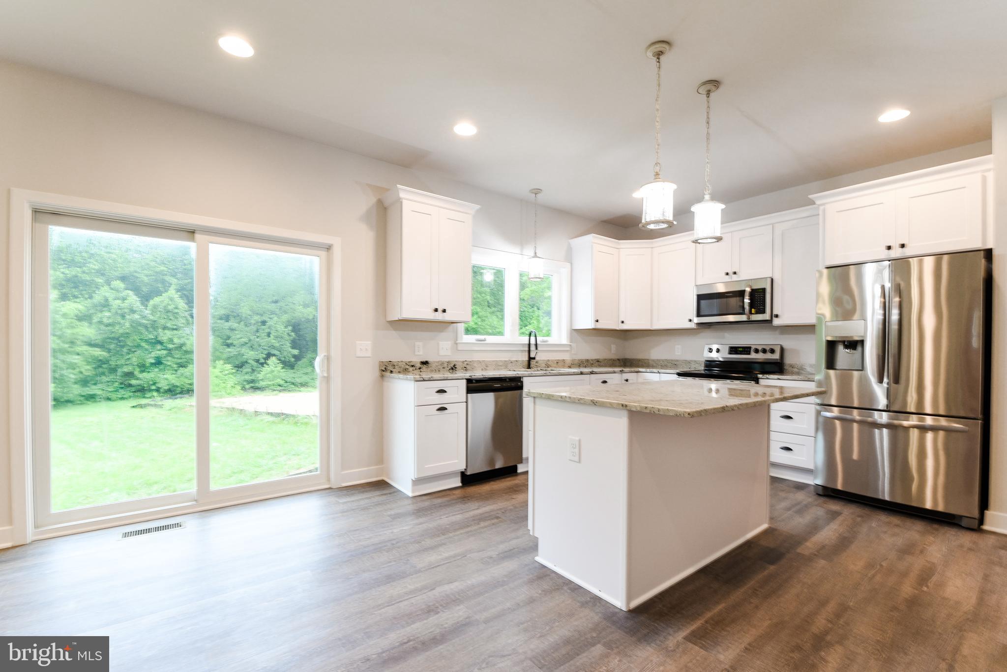 10625 Plank Road Spotsylvania, VA 22553 - Photo 23 of 26 a kitchen with stainless steel appliances granite countertop a refrigerator a sink dishwasher a stove and white cabinets with wooden floor
