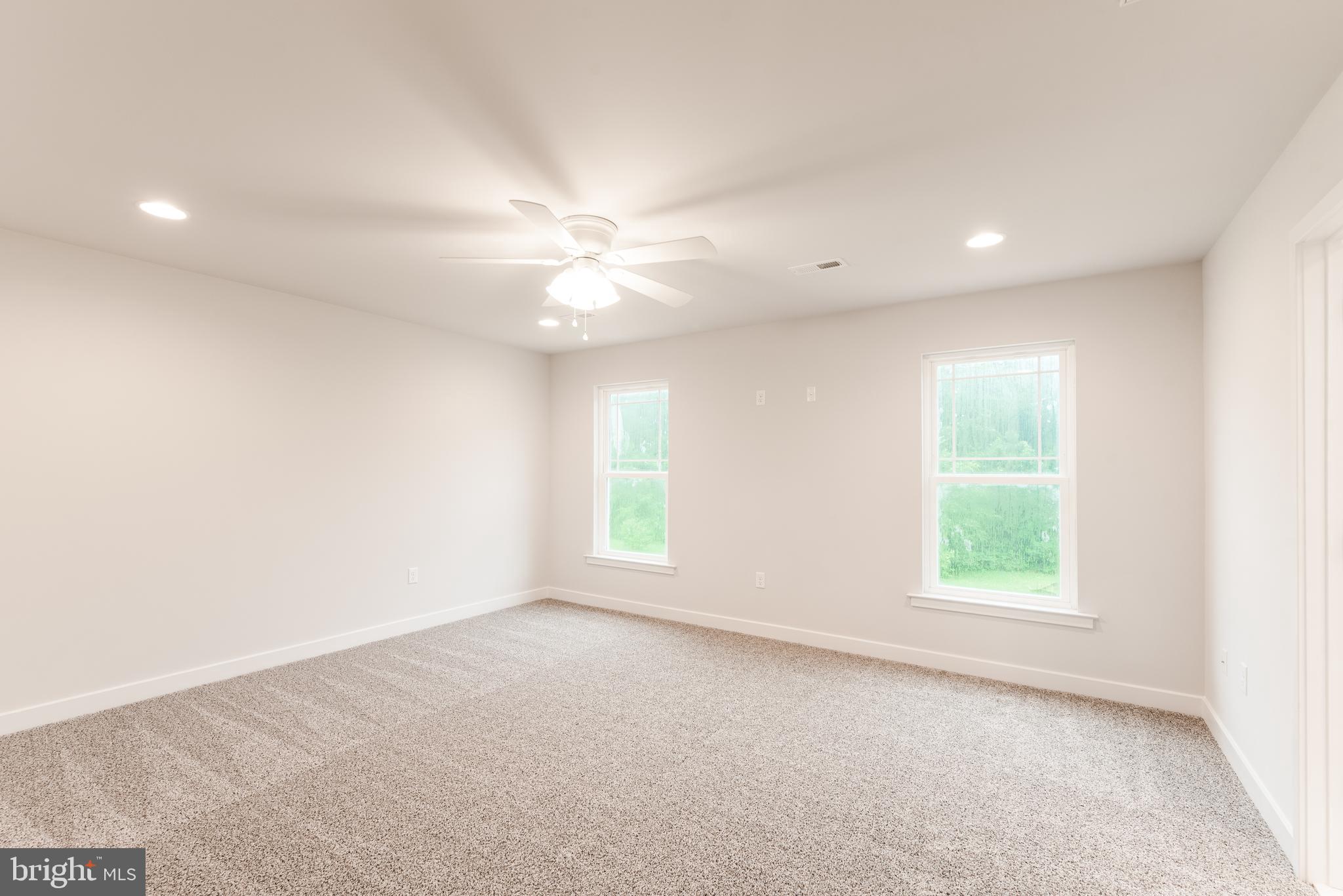 10625 Plank Road Spotsylvania, VA 22553 - Photo 8 of 26 an empty room with windows and fan