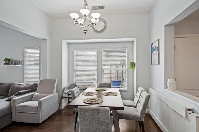 a living room with furniture chandelier and a table