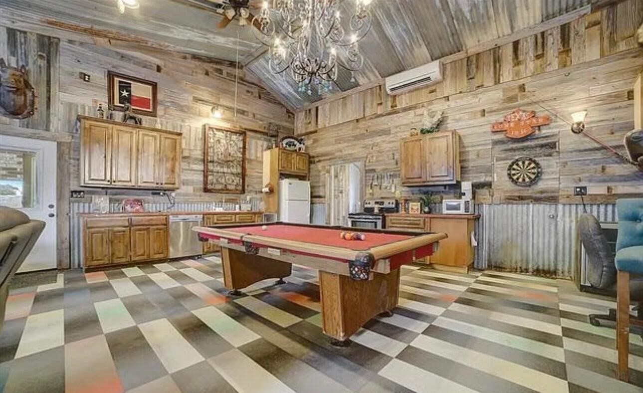 2702 Blue Creek Road La Vernia, TX 78121 - Photo 14 of 31 a kitchen with stainless steel appliances granite countertop a stove a sink and a refrigerator