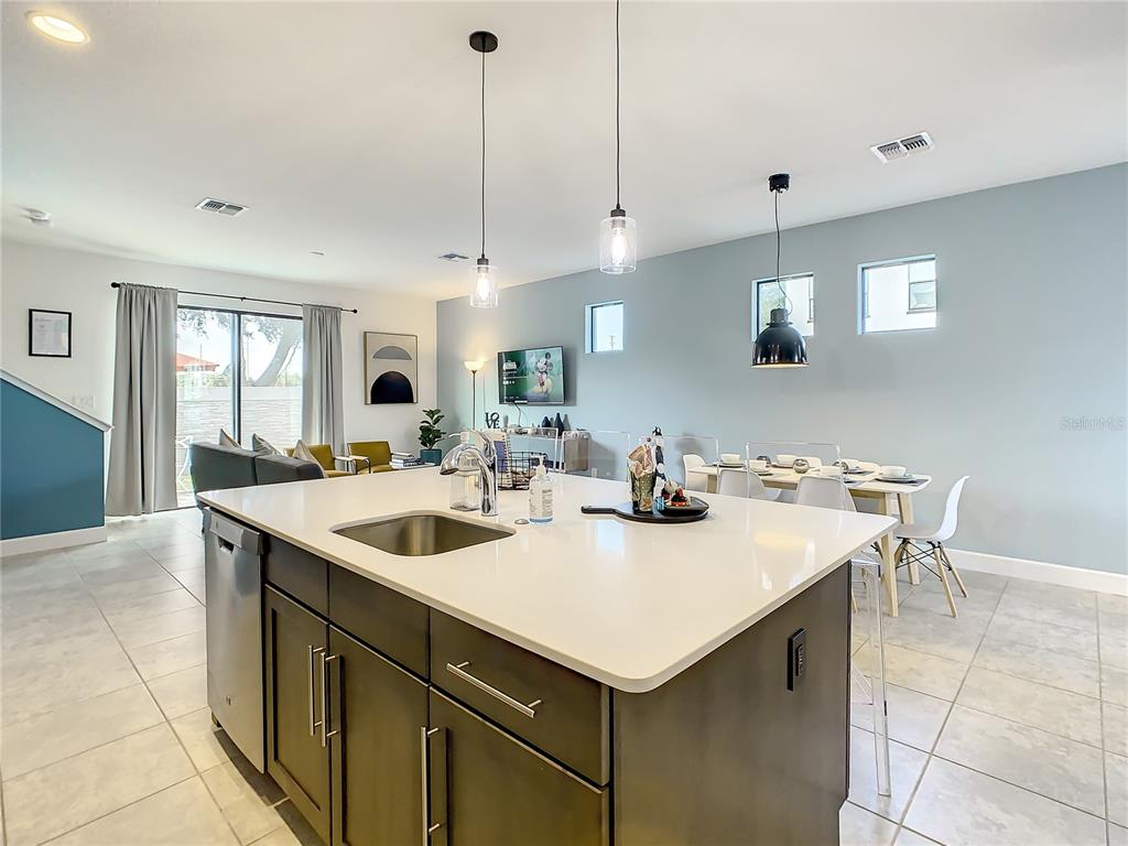 181 Villa Domani Circle Davenport, FL 33896 - Photo 13 of 37 a kitchen with a sink a counter space and living room