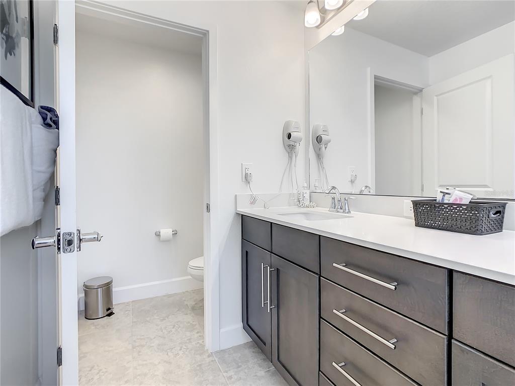 181 Villa Domani Circle Davenport, FL 33896 - Photo 16 of 37 a bathroom with a sink and a mirror