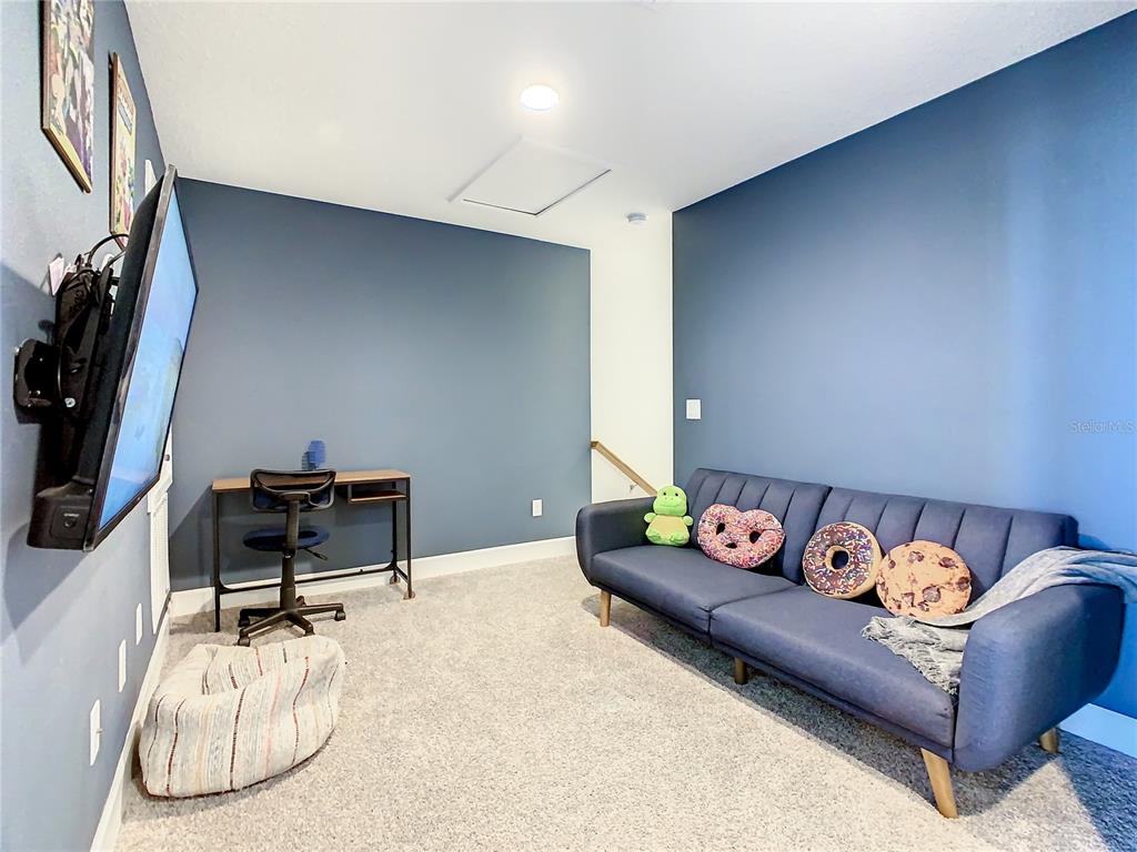 181 Villa Domani Circle Davenport, FL 33896 - Photo 20 of 37 a living room with furniture and a flat screen tv